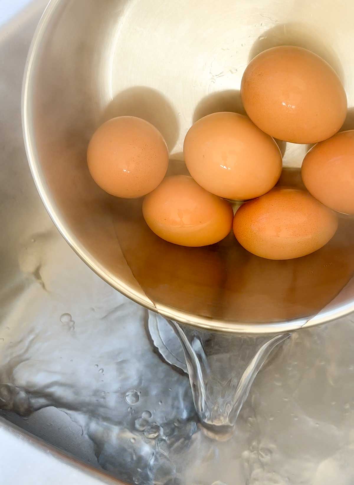 draining boiling water from pot