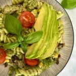 close up of Green Goddess Tuna Pasta Salad with avocado and tomatoes on top