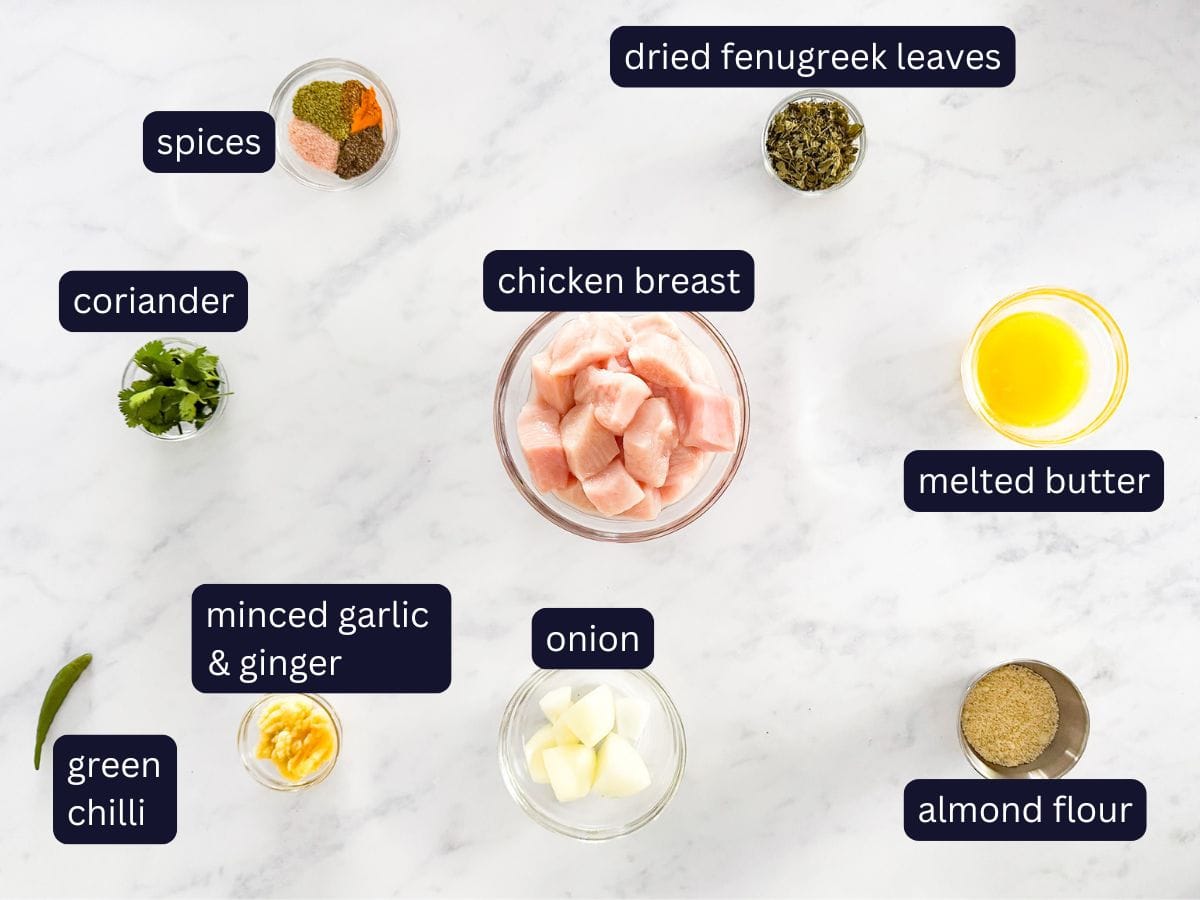 ingredients to make the meatballs including spices, coriander, minced garlic & ginger, green chilli, onion, chicken breast, dried fenugreek leaves, melted butter, almond flour. 